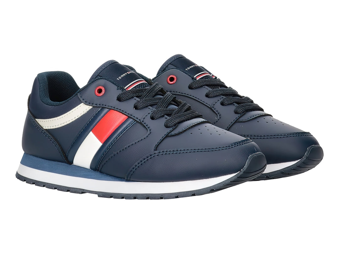 Tenis Tommy Hilfiger azul marino con detalles en blanco y rojo y suela blanca.