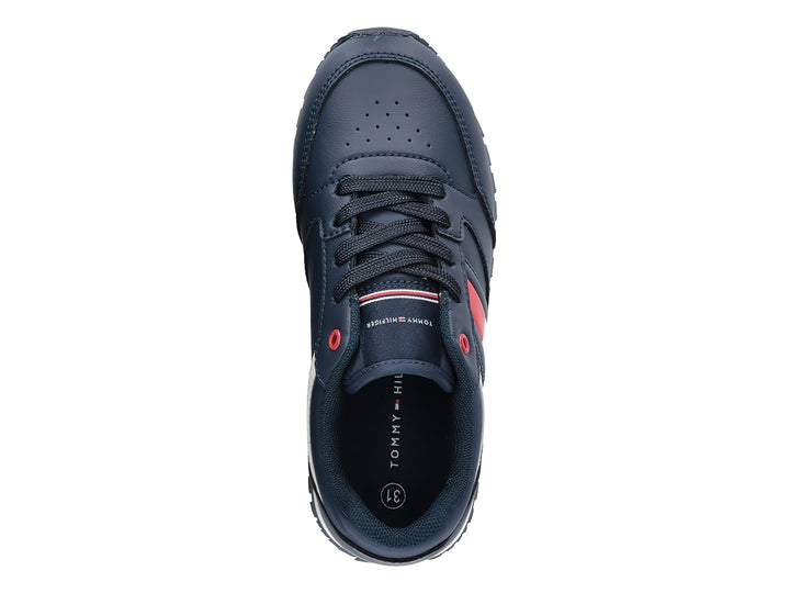Tenis Tommy Hilfiger azul marino con detalles en blanco y rojo y suela blanca.