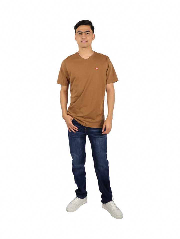 Hombre modelando una playera básica de color tabaco con cuello en V y manga corta.