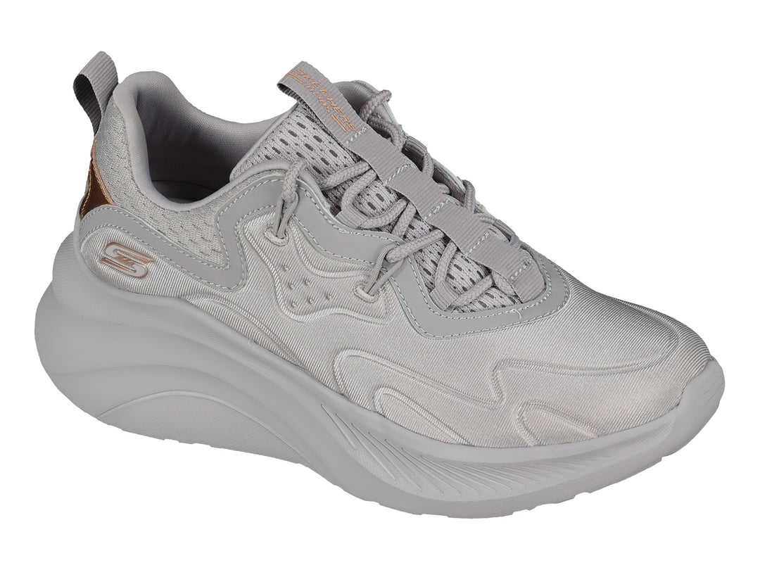 Tenis Skechers color lavanda con suela gruesa y detalles metálicos en oro rosa.