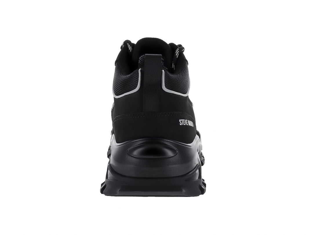 Tenis Steve Madden Henry color negro con suela gruesa y detalles en blanco.