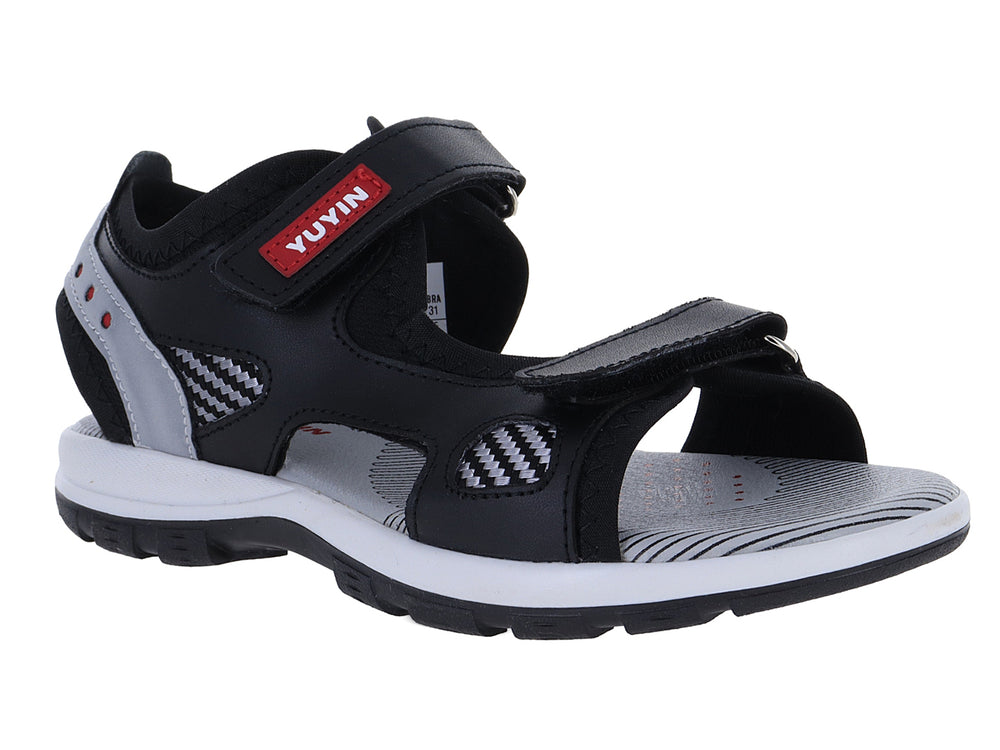 Sandalia deportiva infantil color negro con detalles en gris y suela blanca.