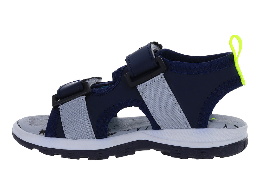 Sandalia infantil color azul marino con lunares blancos y tirador amarillo neón.