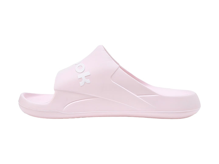 Sandalias slide Reebok en color rosa pálido con logotipo blanco en la banda superior.