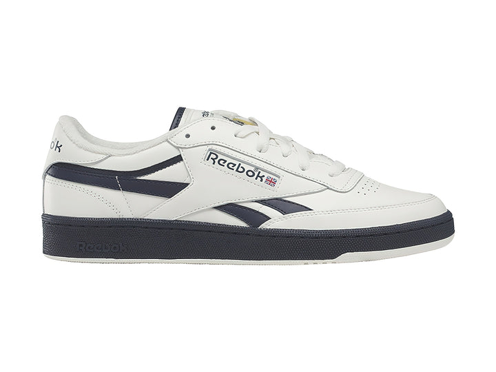 Tenis Reebok blancos con detalles y suela azul marino, estilo vintage.