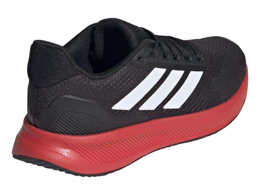 Tenis deportivos Adidas color negro con suela roja y franjas blancas laterales.