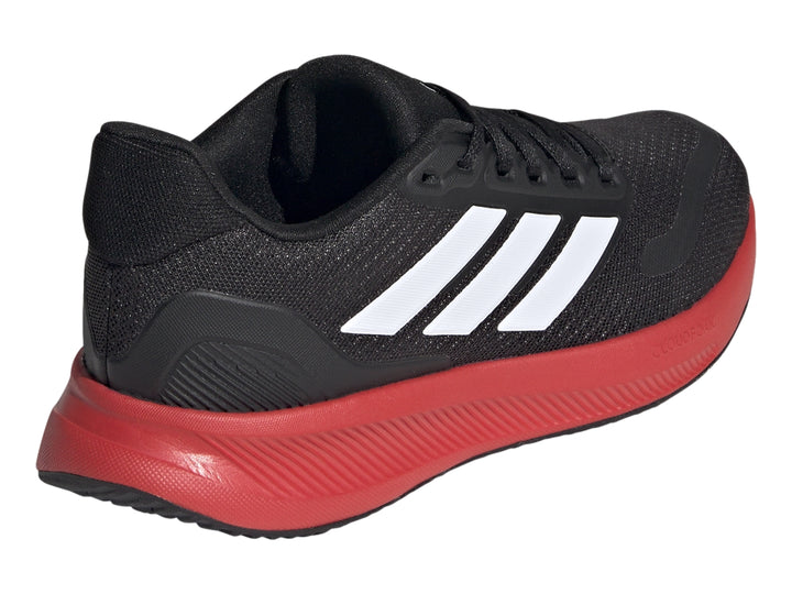 Tenis deportivos Adidas color negro con suela roja y franjas blancas laterales.