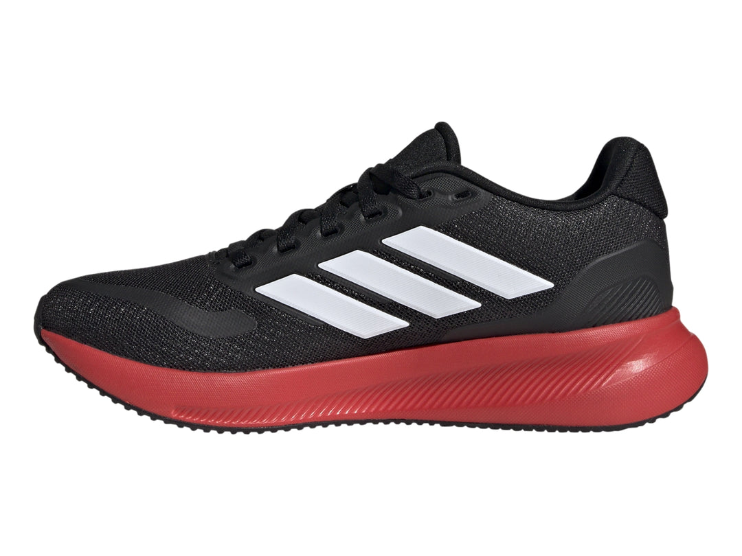 Tenis deportivos Adidas color negro con suela roja y franjas blancas laterales.