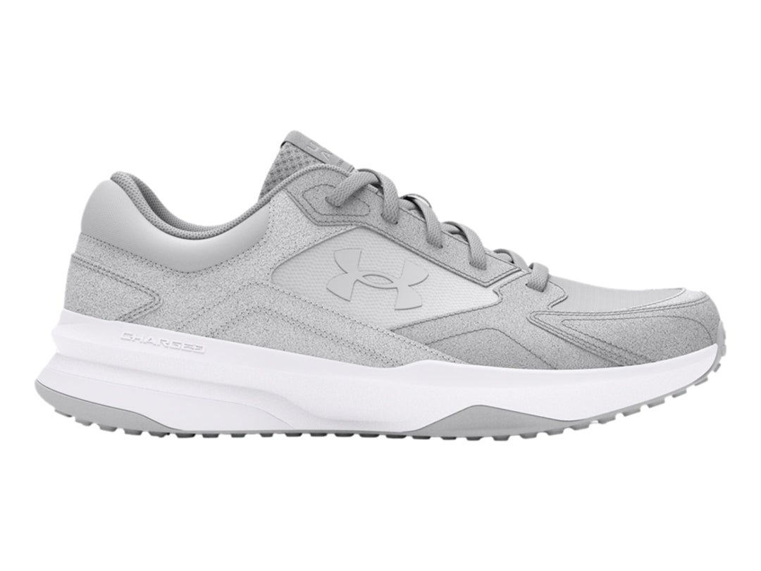 Tenis deportivos Under Armour color gris con suela blanca.