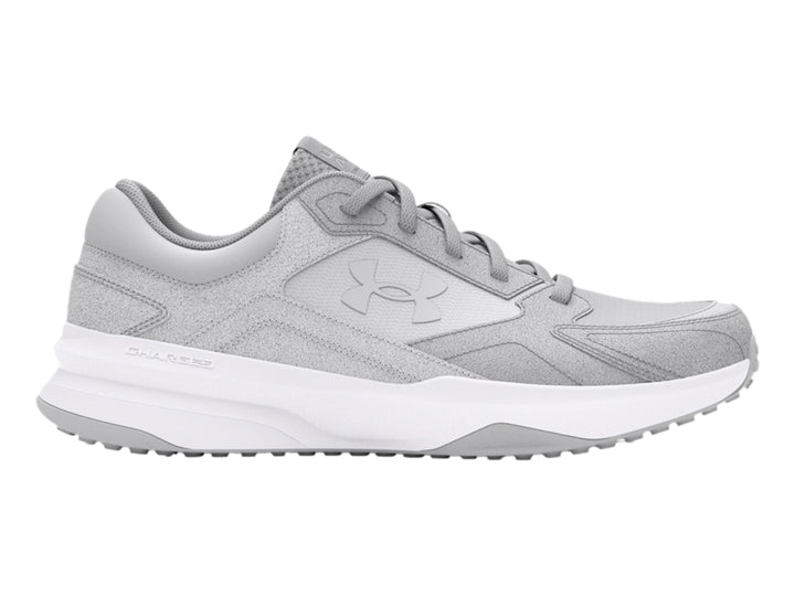 Tenis deportivos Under Armour color gris con suela blanca.