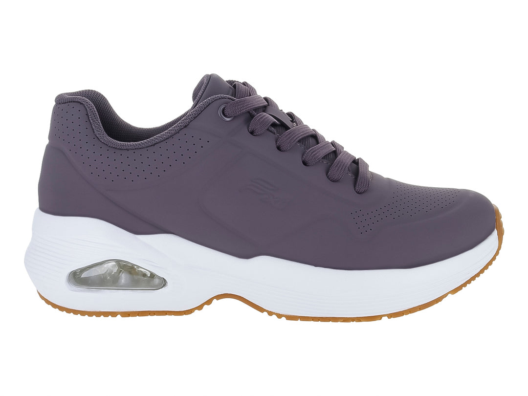 Tenis Flexi color lila con suela blanca y detalle de cámara de aire en el talón.