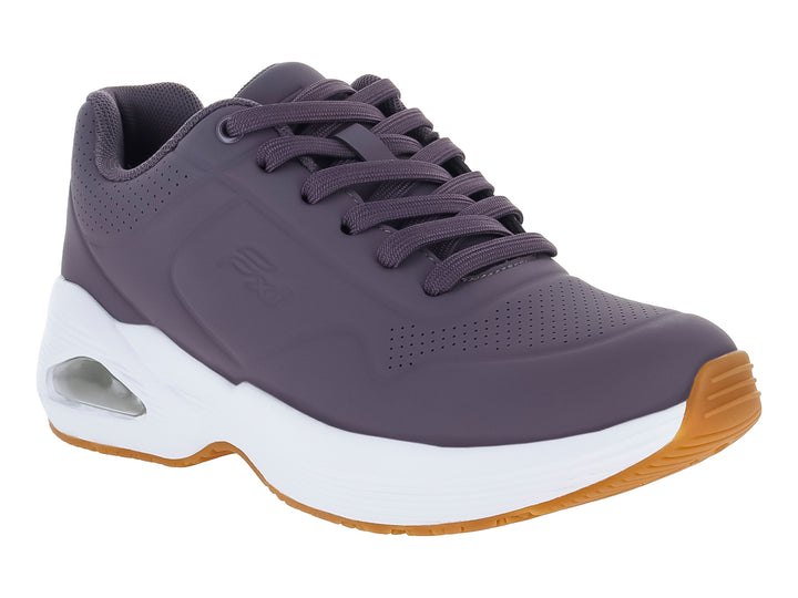 Tenis Flexi color lila con suela blanca y detalle de cámara de aire en el talón.