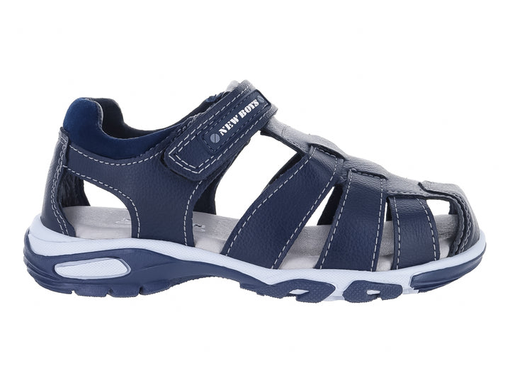 Sandalia cerrada para niño en color azul marino con suela blanca y ajuste de velcro.