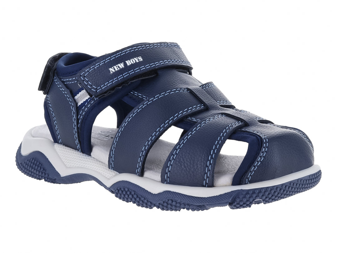 Sandalia para niño color azul marino con suela blanca y correas de cierre con velcro.