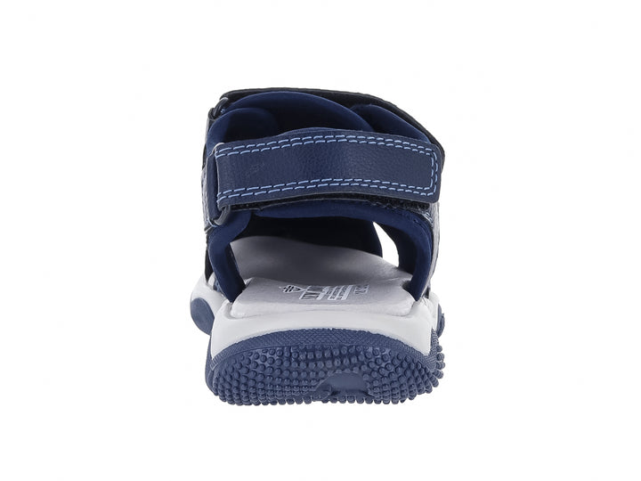 Sandalia para niño color azul marino con suela blanca y correas de cierre con velcro.