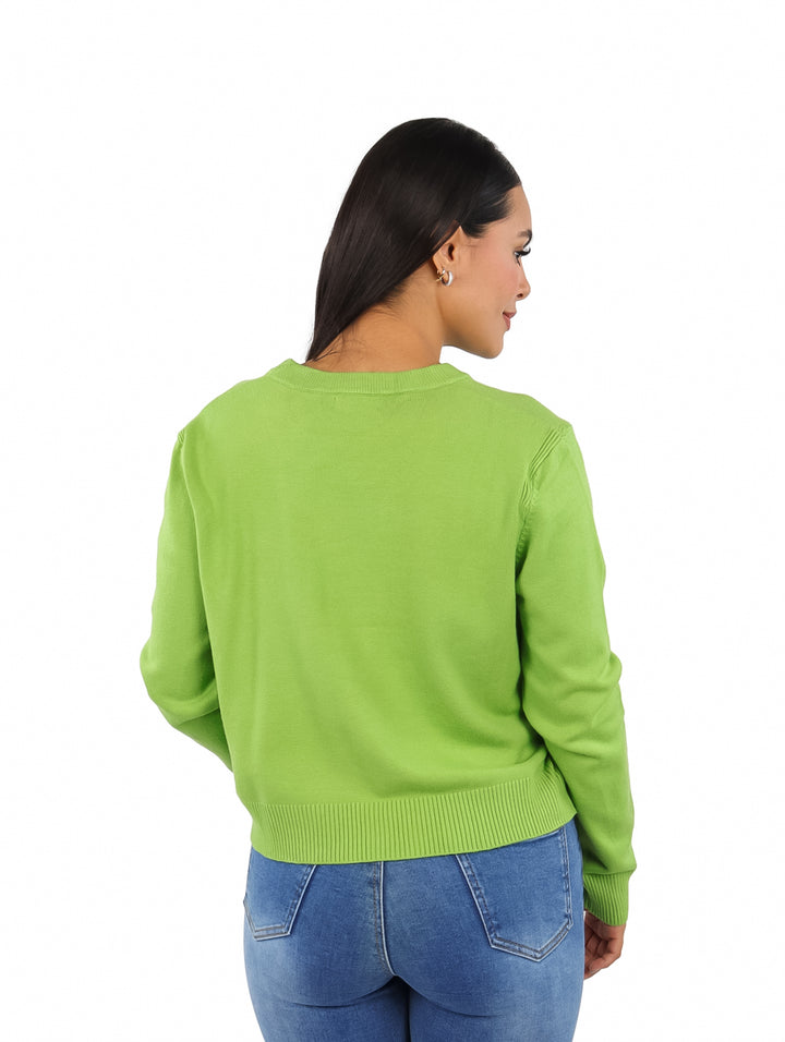 Mujer vistiendo un suéter verde de cuello redondo y manga larga.