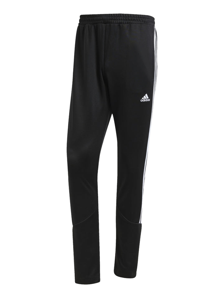 Hombre vistiendo conjunto deportivo Adidas con chaqueta azul y pantalón negro con franjas blancas laterales.