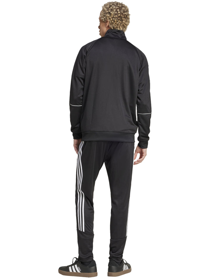 Conjunto deportivo Adidas negro con tres franjas blancas en las mangas y pantalones, incluye chaqueta y pantalón.