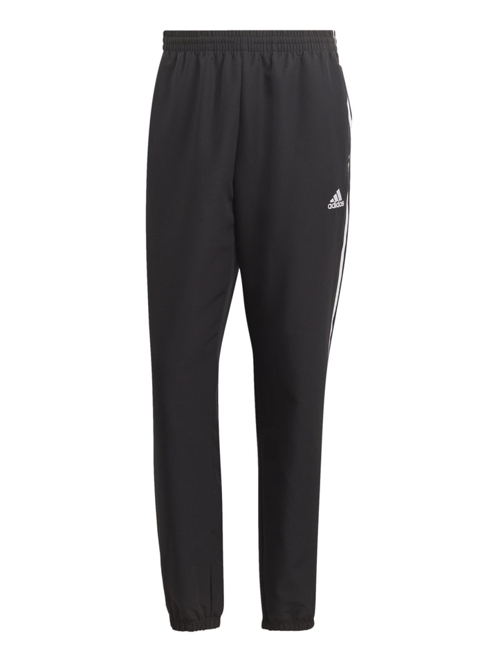 Conjunto deportivo Adidas negro con tres franjas blancas laterales compuesto por chaqueta y pantalón.