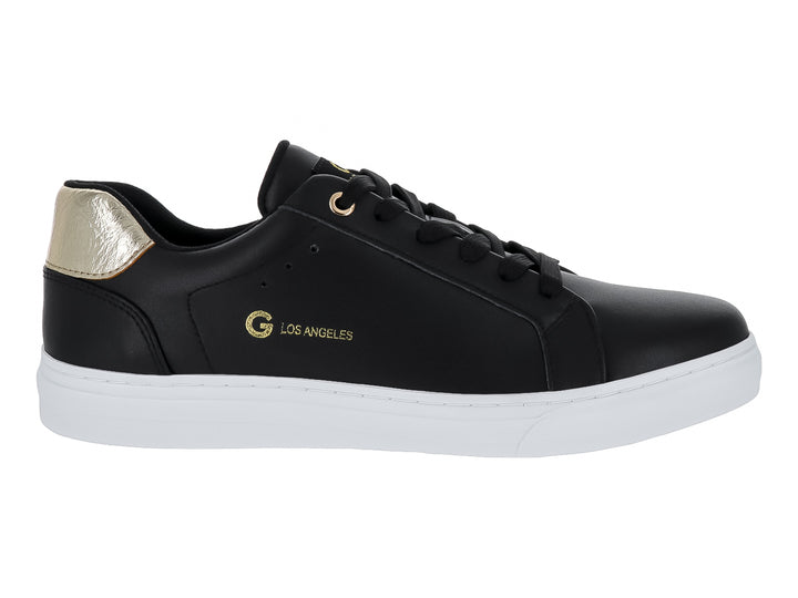Tenis negros de cuero con detalle dorado en el talón y suela blanca.