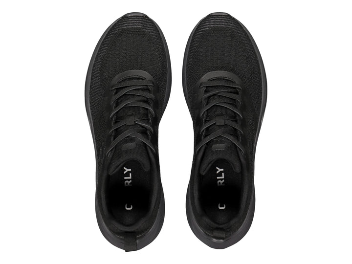 Tenis deportivos Charly color negro con suela gris oscuro y parte superior de tejido transpirable.