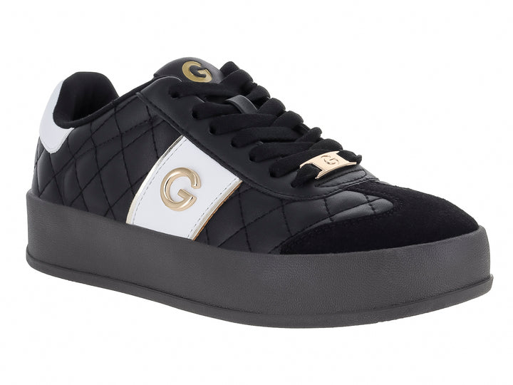 Tenis negros de plataforma con diseño acolchado en diamante y detalles laterales en color blanco.