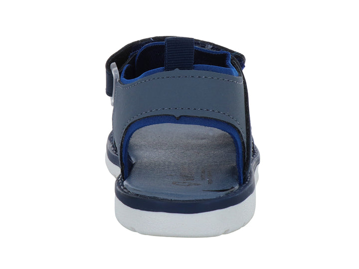 Sandalia infantil color azul marino con suela blanca y cierres de velcro.