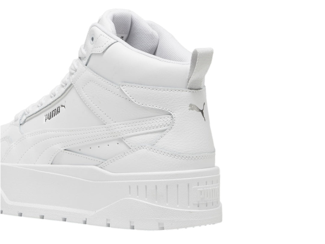 Tenis PUMA blancos de corte medio con suela de plataforma gruesa.