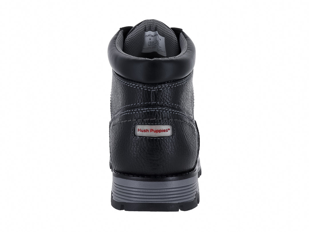 Botín de cuero negro Hush Puppies con suela gris y textura granulada.
