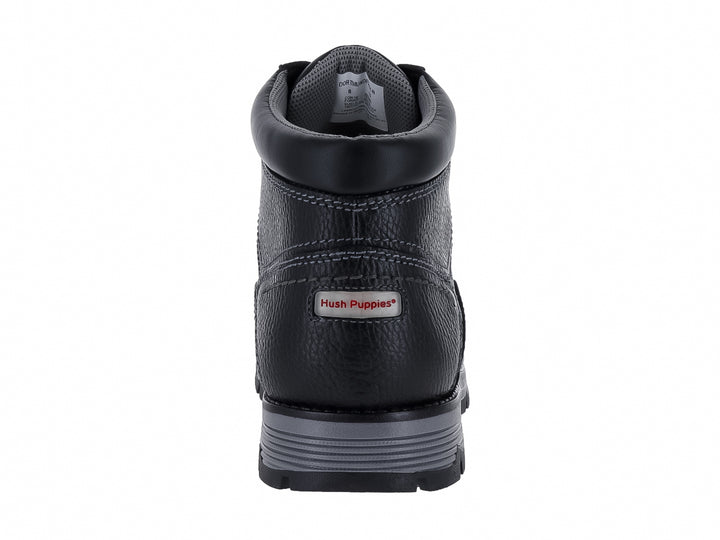 Botín de cuero negro Hush Puppies con suela gris y textura granulada.