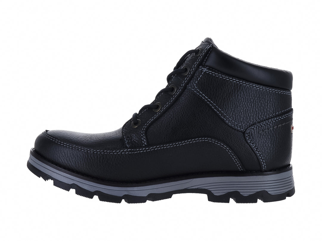 Botín de cuero negro Hush Puppies con suela gris y textura granulada.
