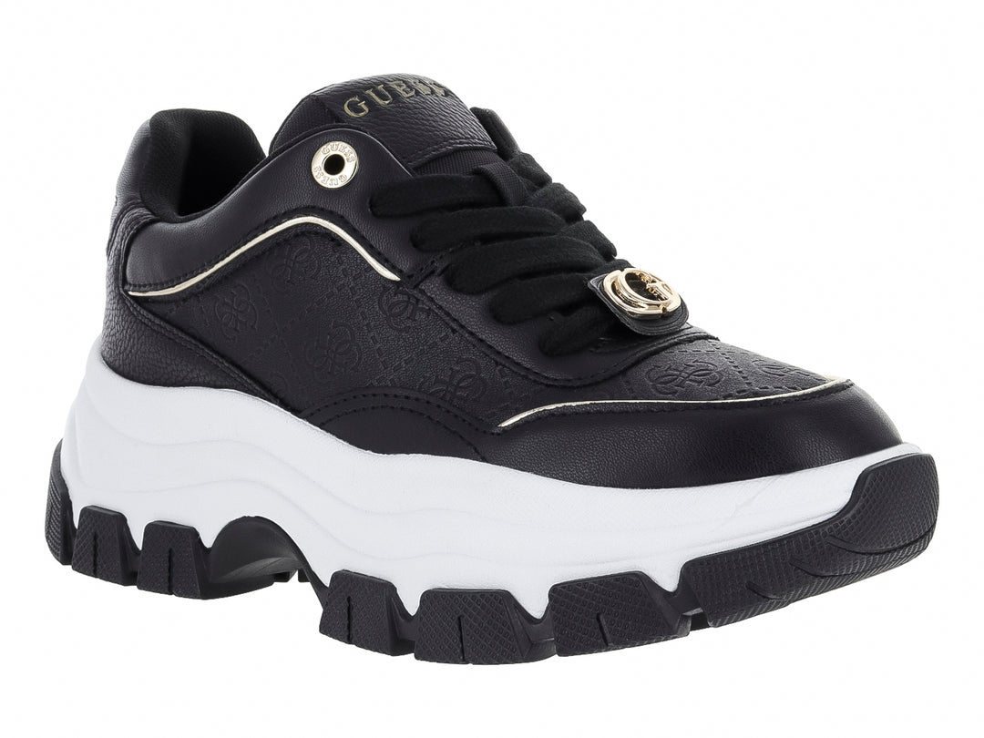 Tenis Guess negros con suela blanca de plataforma y detalles dorados.