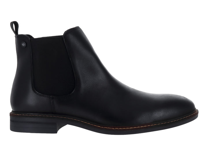 Botín negro de cuero estilo Chelsea con panel elástico lateral y costuras cafés en la suela.