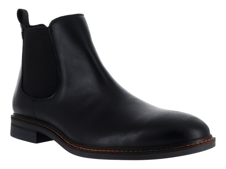 Botín negro de cuero estilo Chelsea con panel elástico lateral y costuras cafés en la suela.