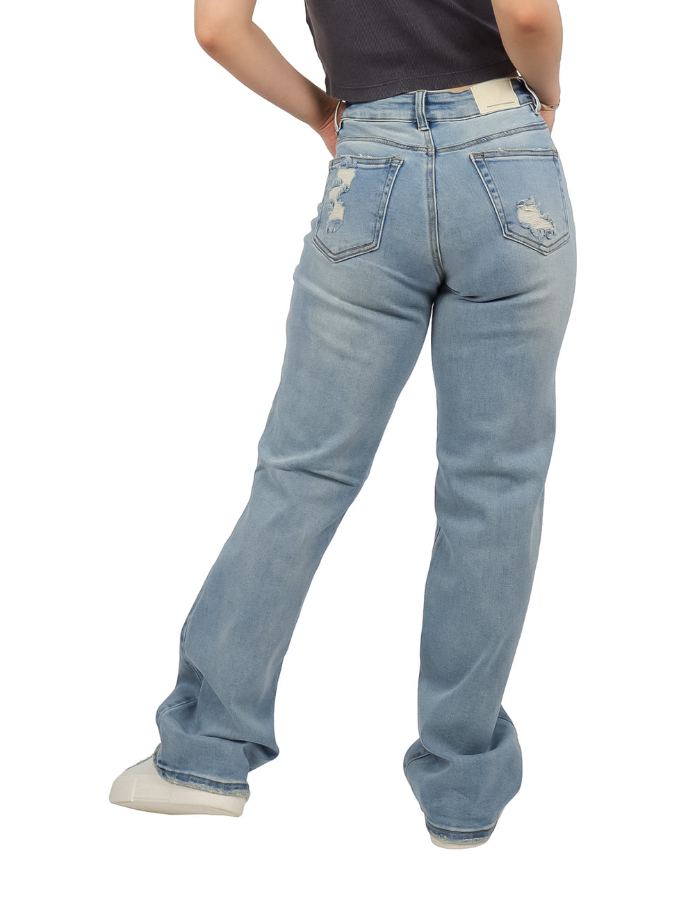 Pantalones jeans anchos de color azul claro con detalles de destrucción en las rodillas y muslos.