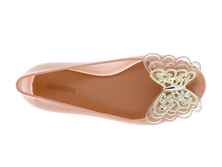 Zapato plano Mini Melissa color oro con adorno brillante en la punta.