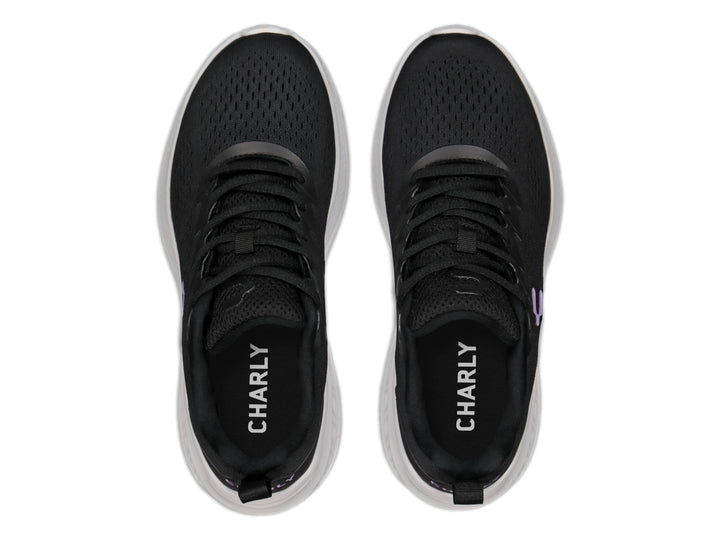Tenis deportivos Charly color negro con suela blanca y logo morado.