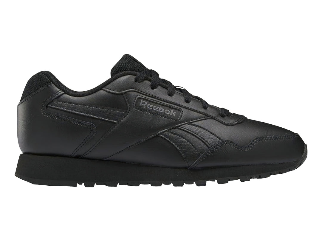 Tenis deportivos Reebok color negro con suela negra y logotipo lateral.