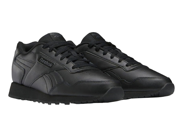 Tenis deportivos Reebok color negro con suela negra y logotipo lateral.