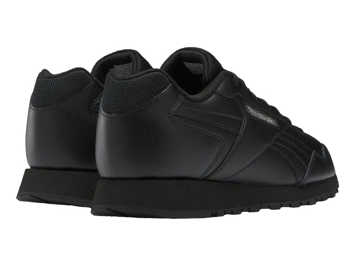 Tenis deportivos Reebok color negro con suela negra y logotipo lateral.