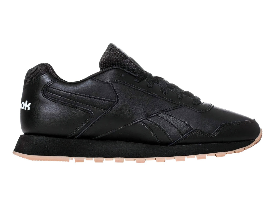 Tenis deportivos Reebok color negro con suela beige y logotipo blanco.