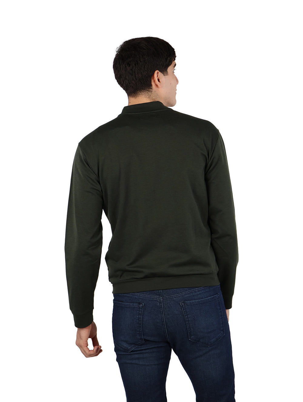 Hombre vistiendo una chamarra bomber color verde militar con cierre frontal y pantalones azul marino.