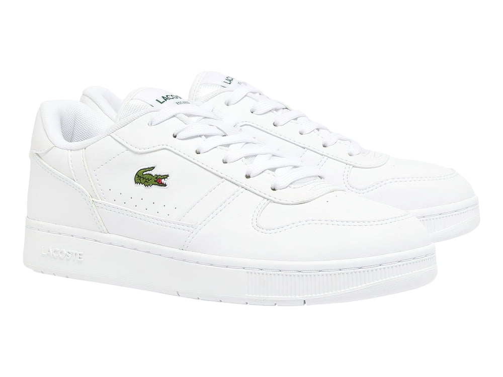 Tenis blancos para niños marca Lacoste con logotipo de cocodrilo verde en el lateral.