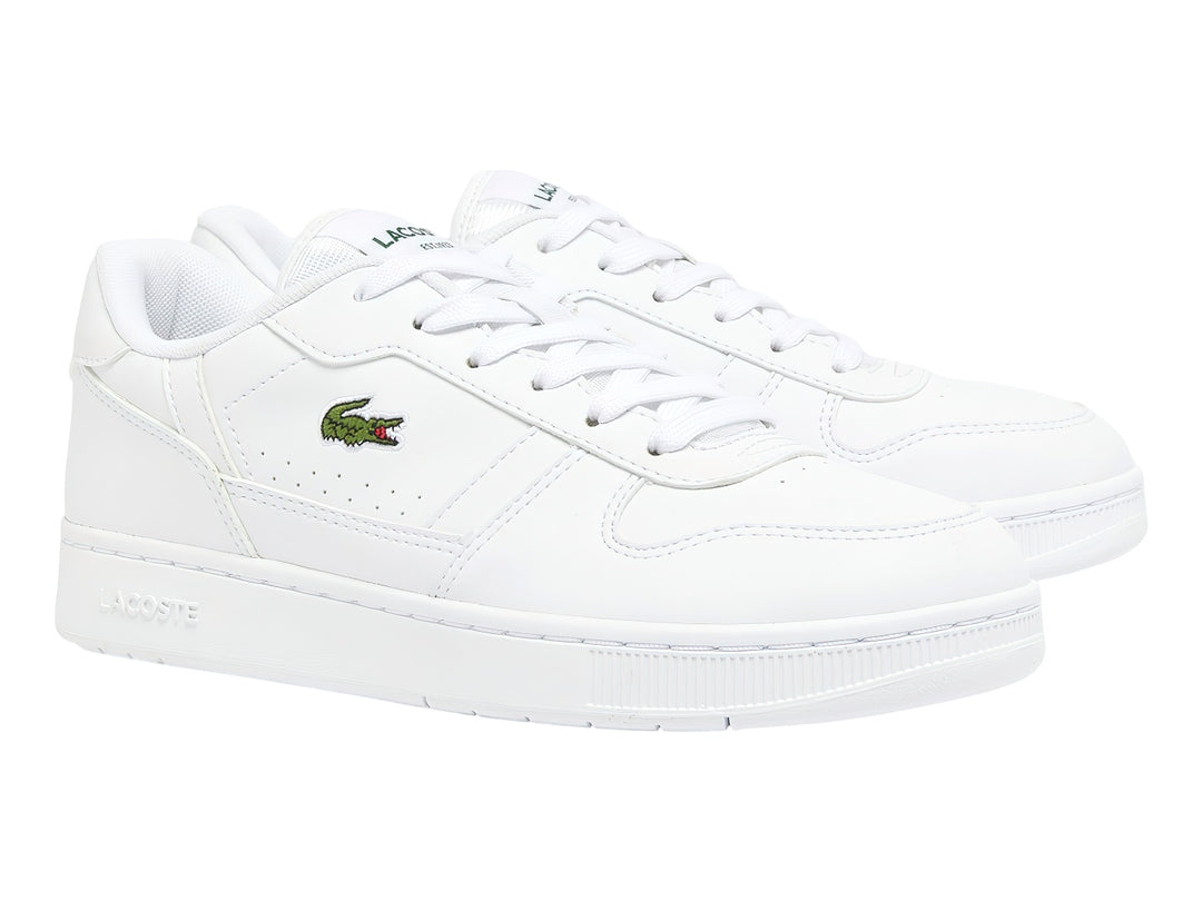 Tenis blancos para niños marca Lacoste con logotipo de cocodrilo verde en el lateral.