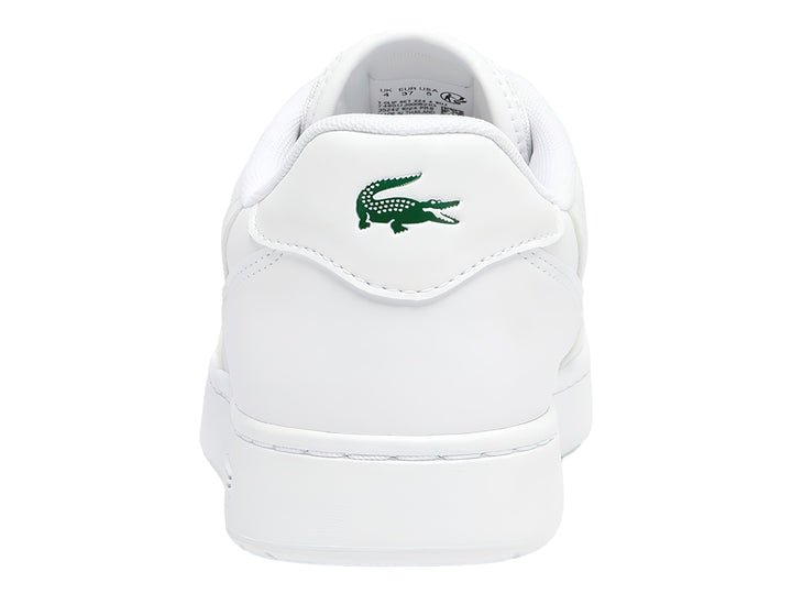 Tenis blancos para niños marca Lacoste con logotipo de cocodrilo verde en el lateral.