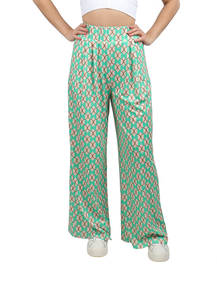 Pantalón palazzo verde con estampado geométrico de círculos en tonos beige y marrón.