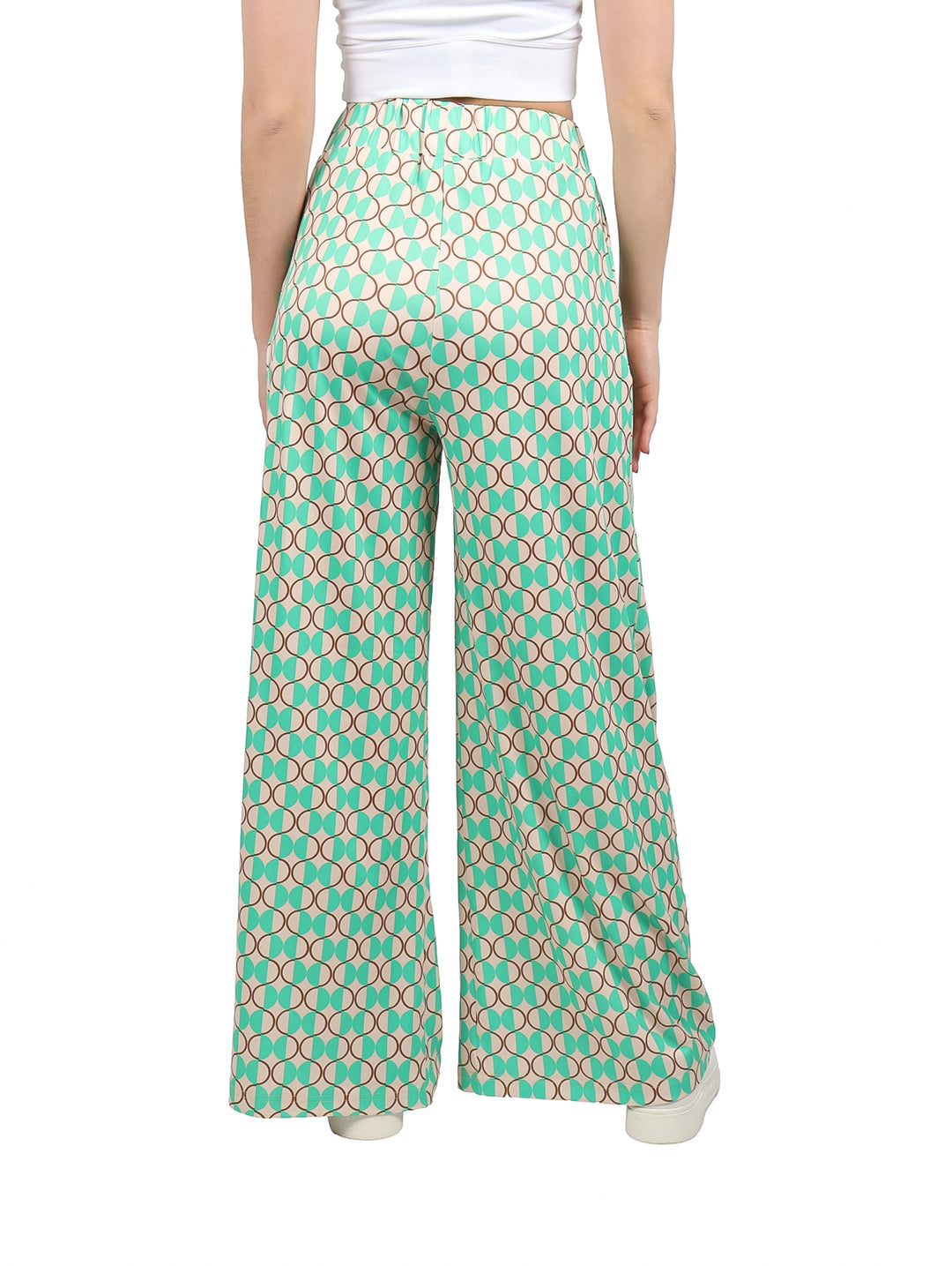Pantalón palazzo verde con estampado geométrico de círculos en tonos beige y marrón.