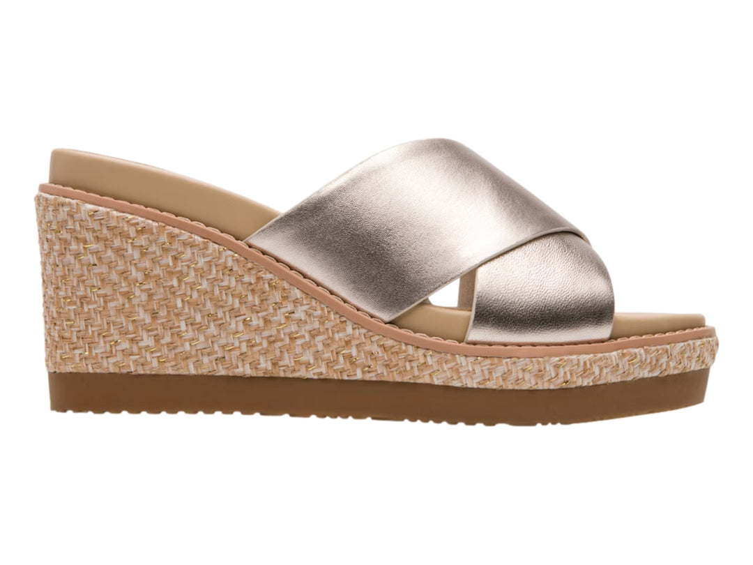 Sandalia de cuña color oro con plataforma tejida en beige y suela marrón.