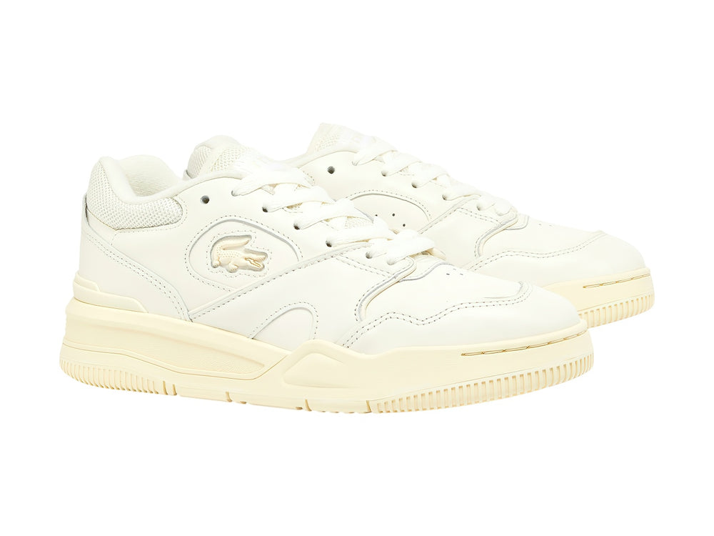 Tenis Lacoste color blanco roto con suela amarillo claro, diseño deportivo y casual.