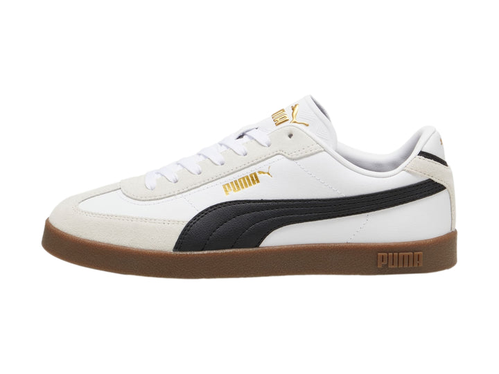 Tenis PUMA blancos con franja negra, punta gris y suela color caramelo.